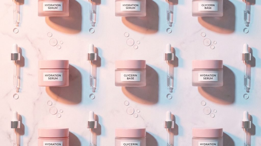 Flatlay of hydrating serums and glycerin droppers on a marble background in 16:9 aspect ratio.