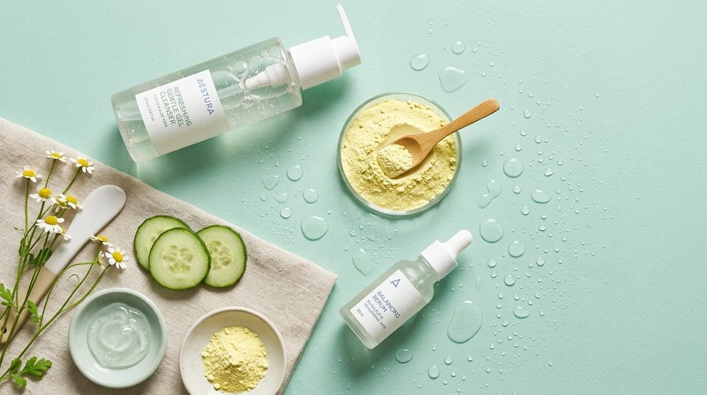 Clear skincare gel bottle and raw sulfur powder dish on seafoam green background.